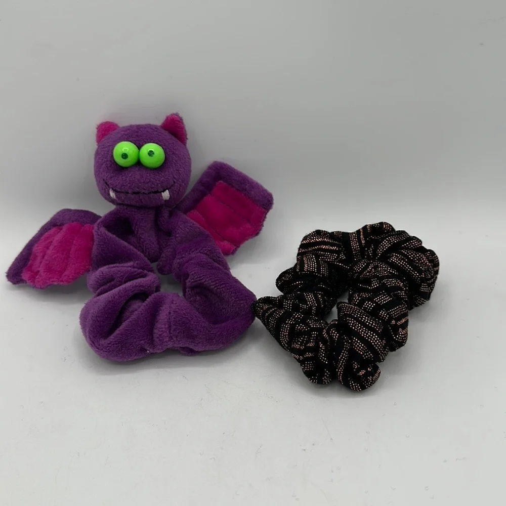 Hair scrunchies: one bat-shaped and one black/copper